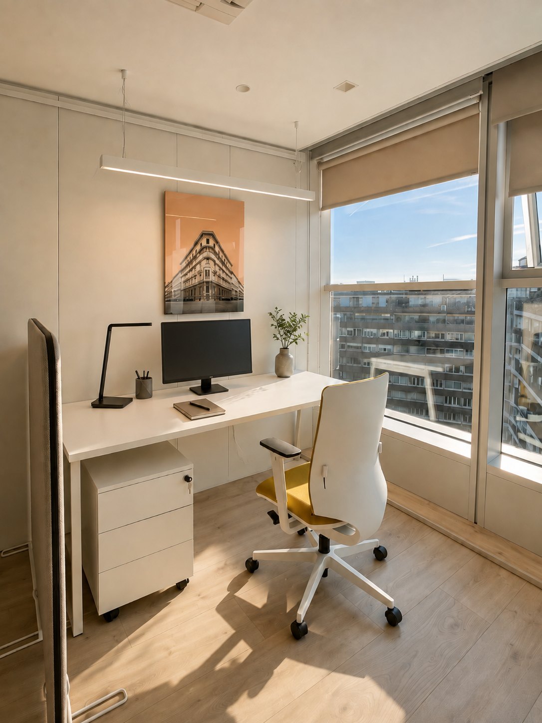 A single-person enclosed office: a white desk in front of the façade window, a yellow-green task chair, a building image printed on glass on the wall