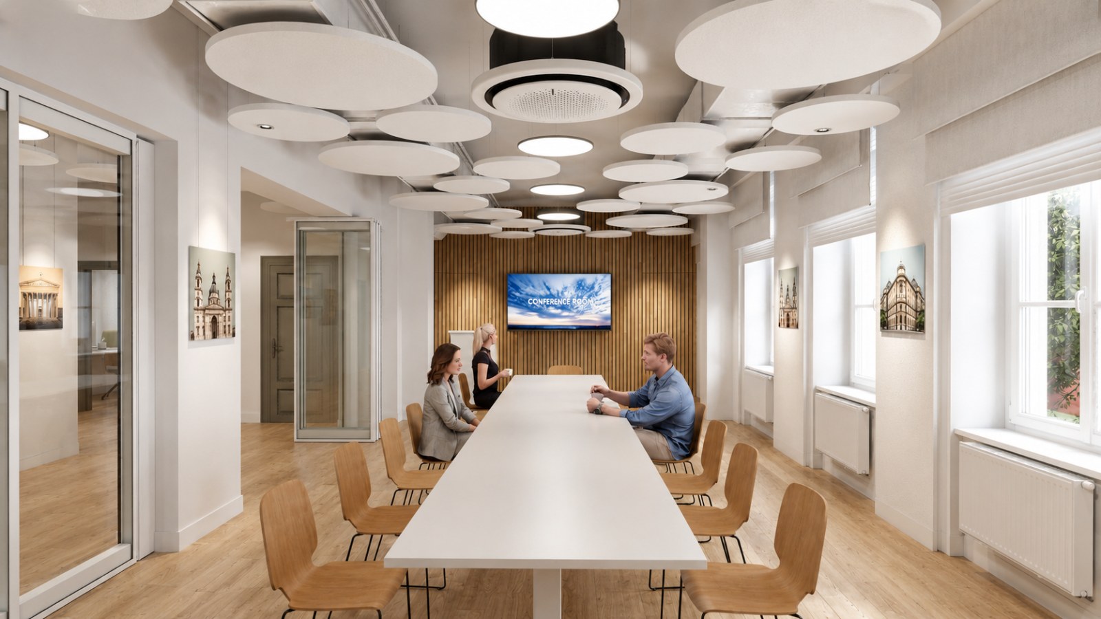 Meeting room in a Gdańsk loft office with circular acoustic panels floating below the soffit