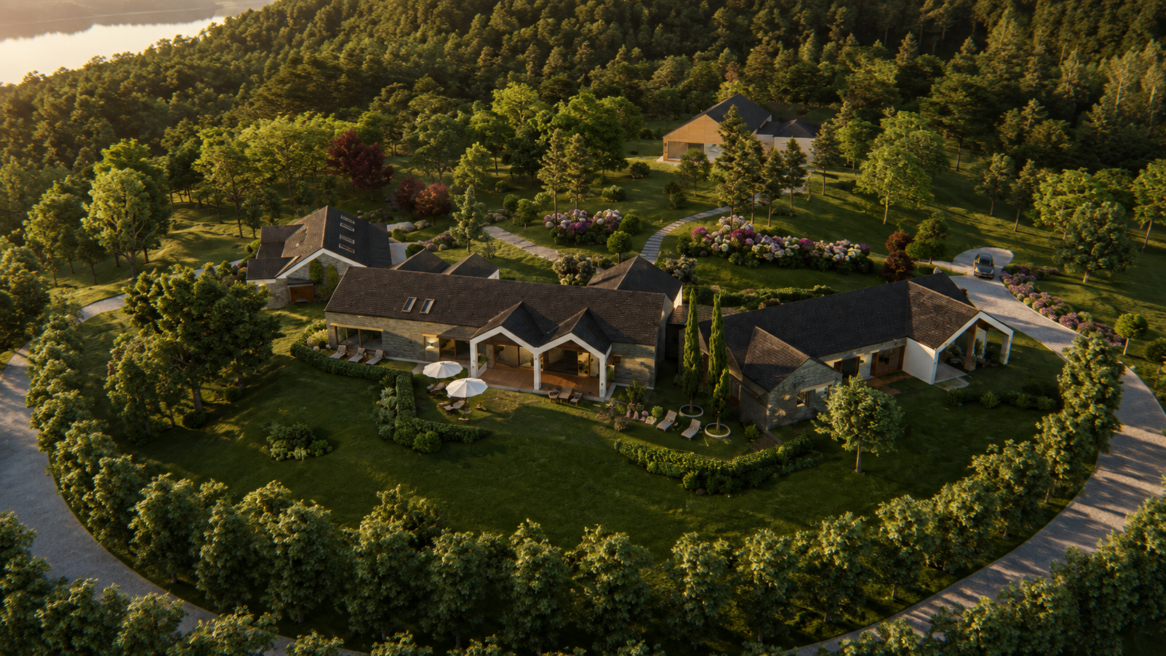 The four-and-a-half-hectare estate from above: the building group among lawns and hedges, surrounded by existing trees, a gravel drive and water in the distance